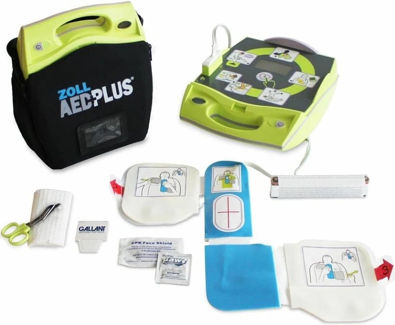 Zoll AED Plus defibrillator with lime green carrying case, electrode pads, and instruction manuals displayed